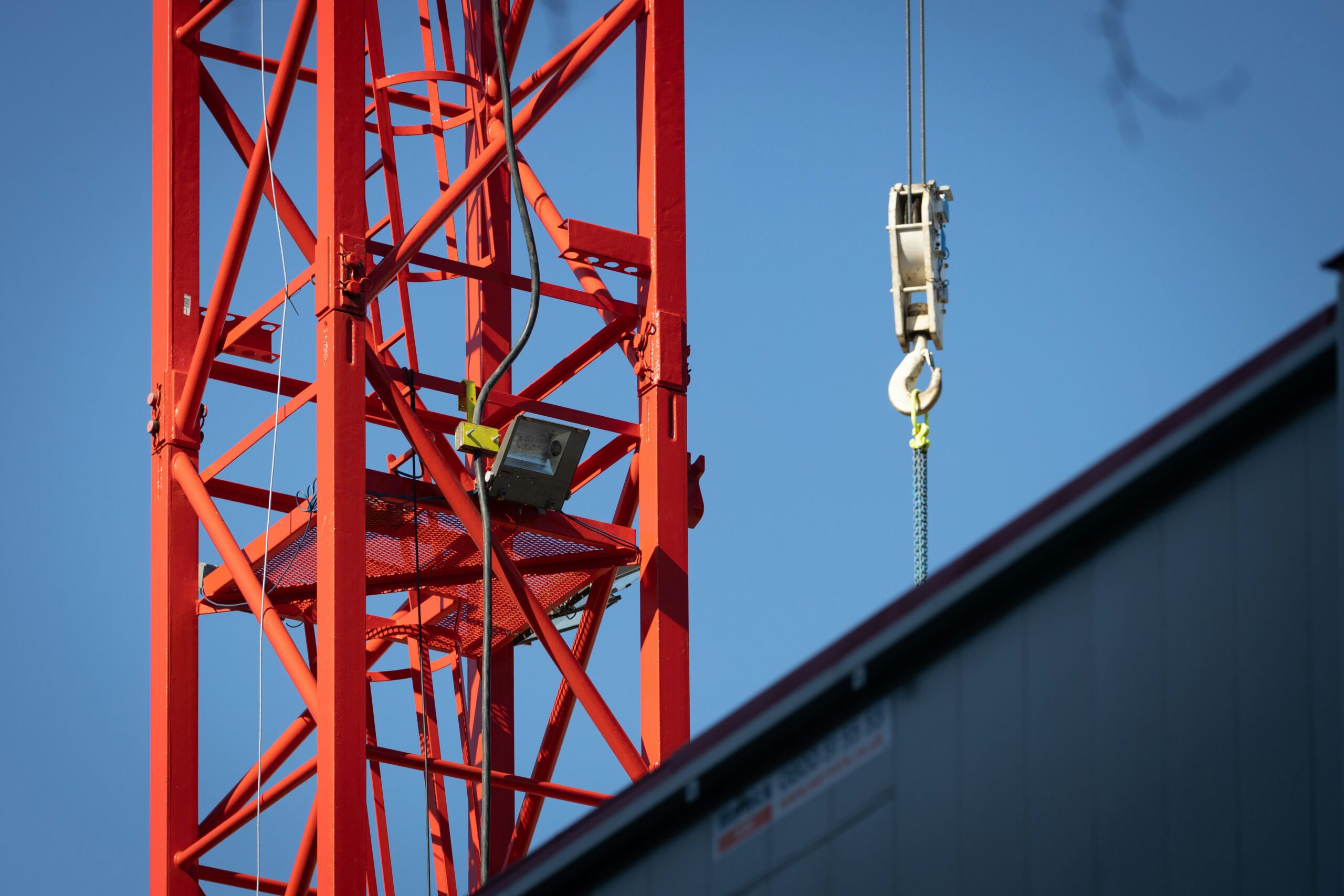 a crane that is hanging from the side of a building